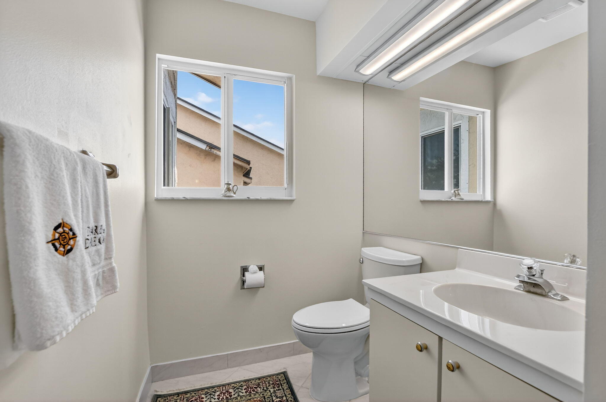 23181 Fountain View Drive, Unit B Boca Raton, FL 33433 - Photo 17 of 21 a bathroom with a sink a toilet and shower