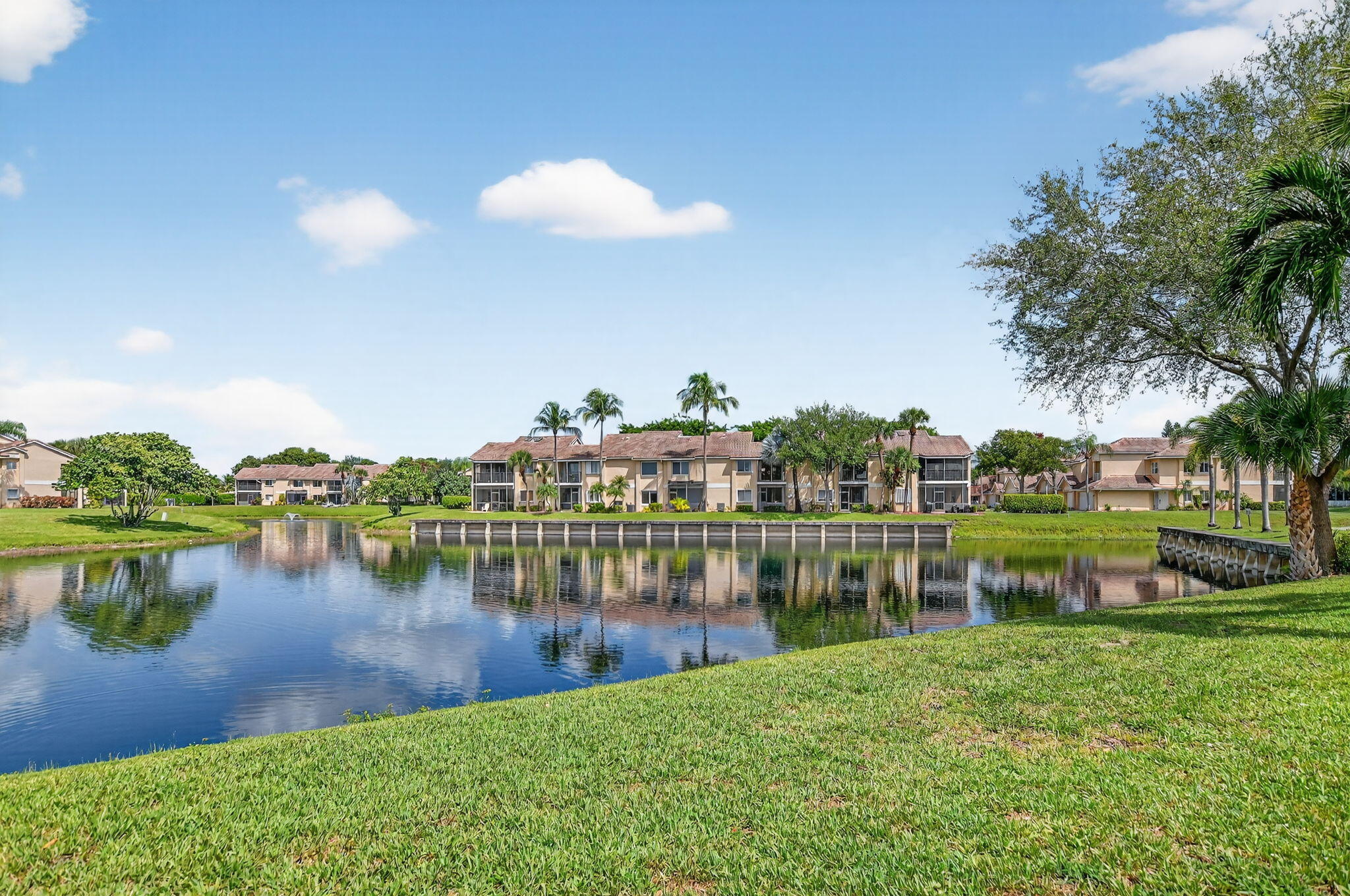 23181 Fountain View Drive, Unit B Boca Raton, FL 33433 - Photo 2 of 21 a view of a lake with houses in the back