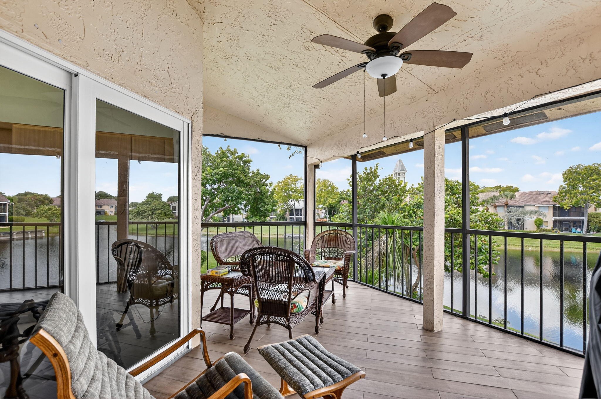 23181 Fountain View Drive, Unit B Boca Raton, FL 33433 - Photo 5 of 21 a view of a patio with a table chairs and a floor to ceiling window