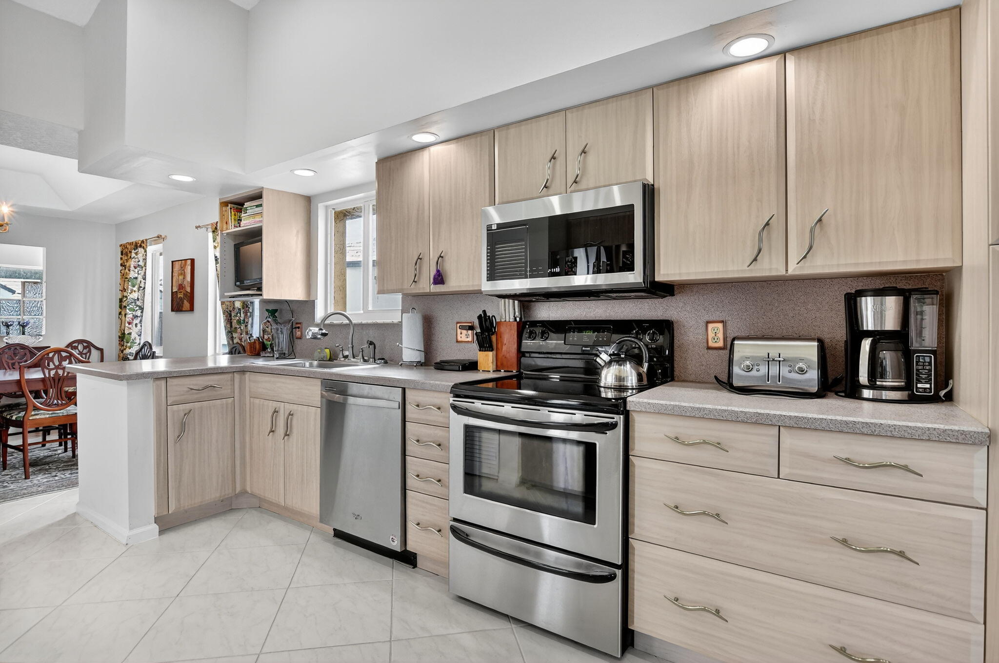 23181 Fountain View Drive, Unit B Boca Raton, FL 33433 - Photo 6 of 21 a kitchen with granite countertop white cabinets and stainless steel appliances