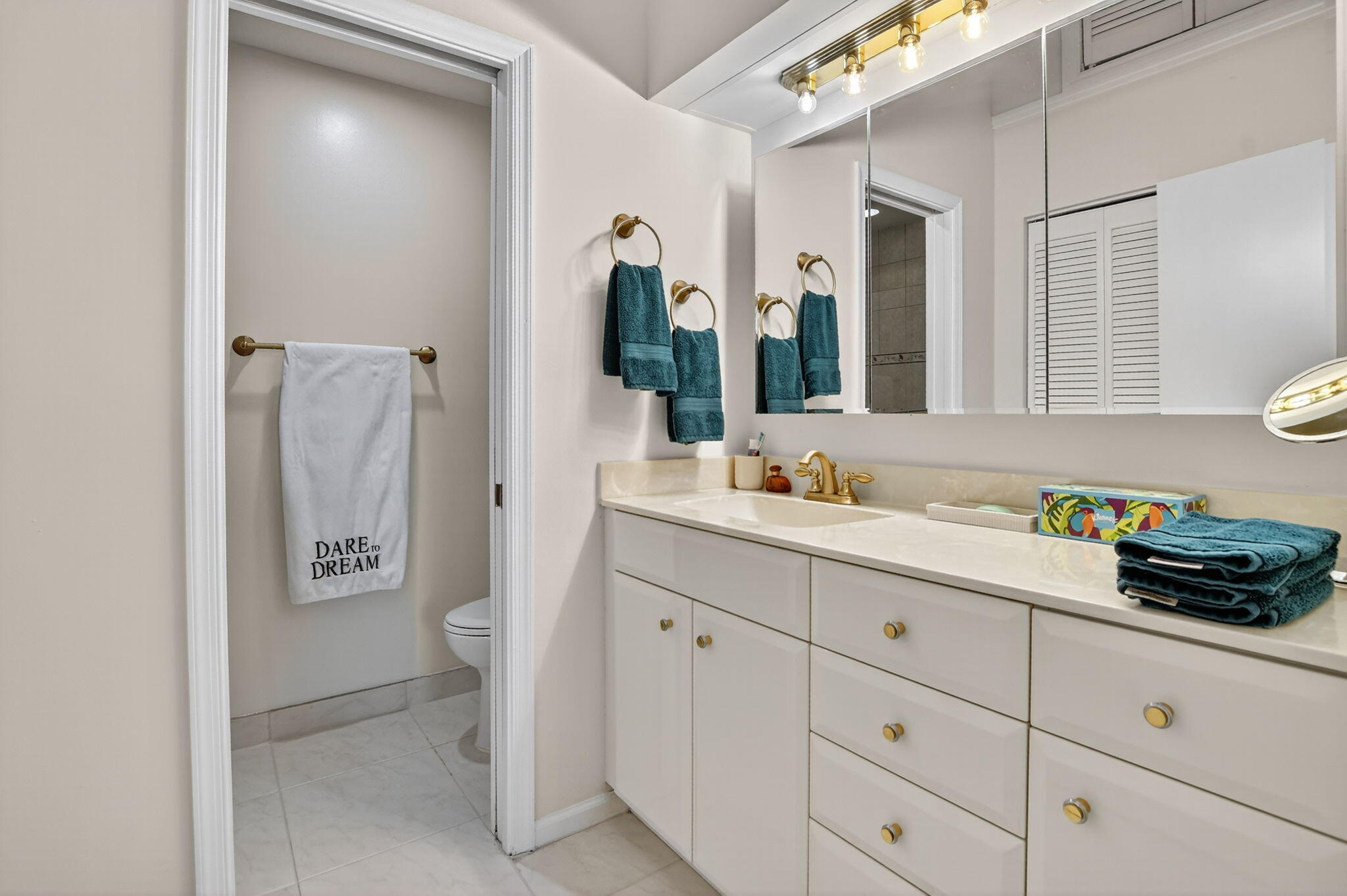 23181 Fountain View Drive, Unit B Boca Raton, FL 33433 - Photo 10 of 21 a bathroom with a double vanity sink and mirror
