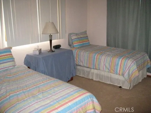 a bedroom with a bed and a large mirror