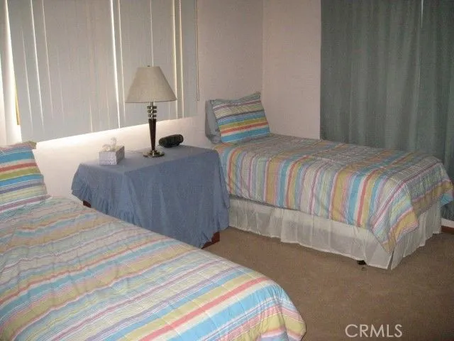 a bedroom with a bed and a large mirror