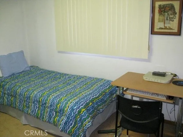 a bedroom with a bed and a table in it