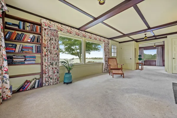 a view of a room with furniture and floor to ceiling window