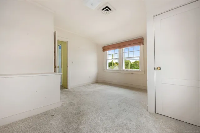 a view of an empty room and a window