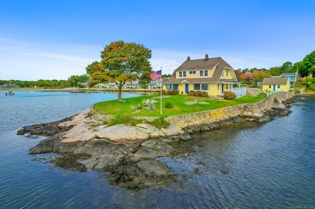 a view of a house with a yard and lake view