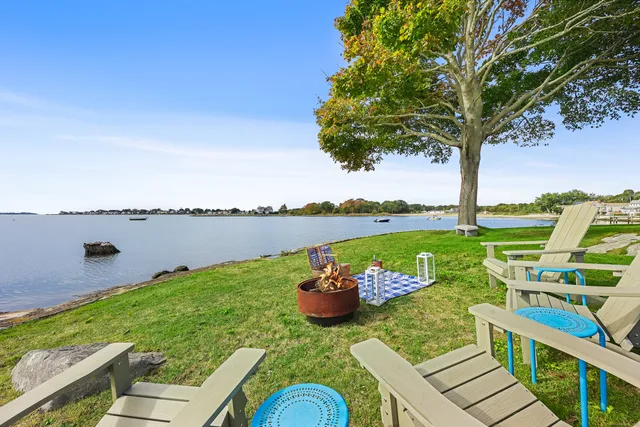 a view of a lake with couches in front of house