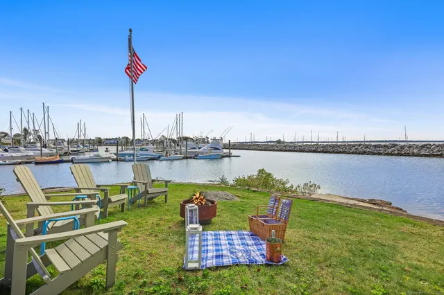 a view of a lake with a table and chairs