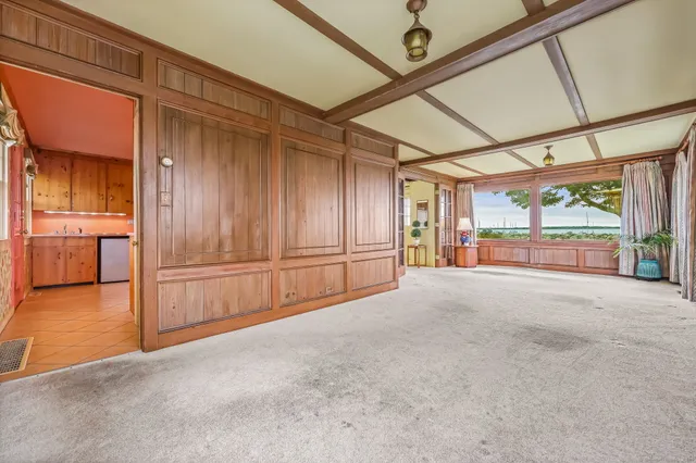 a view of a hallway with wooden walls