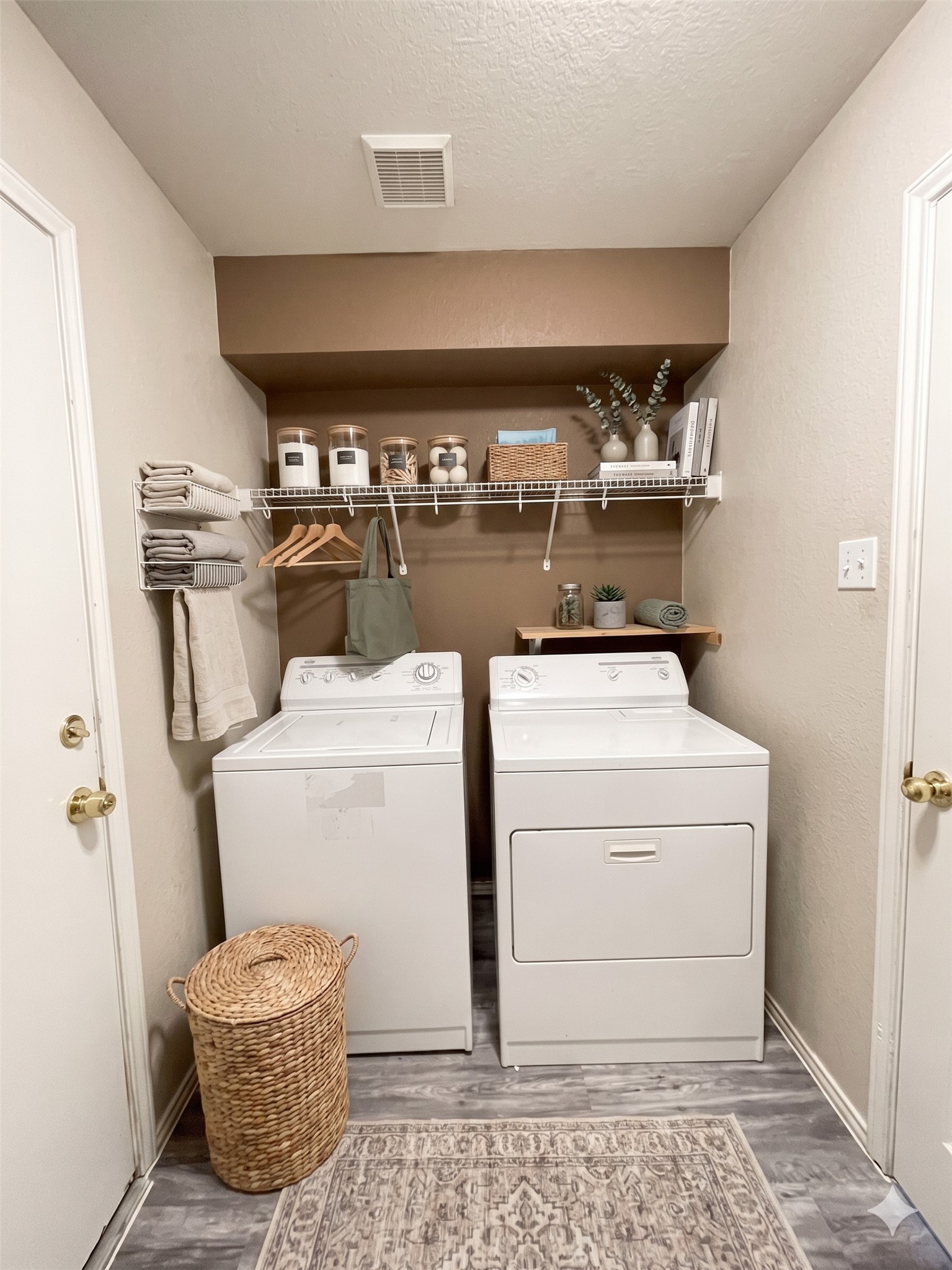 3638 Windhill Loop Round Rock, TX 78681 - Photo 27 of 32 Dedicated laundry area featuring a washer and dryer, wood-finish flooring, overhead wire shelving, and built-in wall shelving for organization