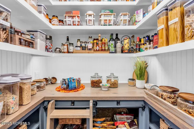 a bathroom with a sink double vanity mirror and toilet