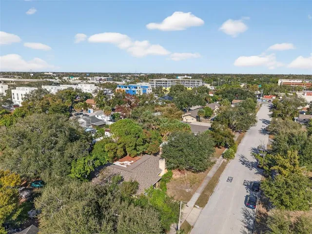 an aerial view of residential building with outdoor space and trees