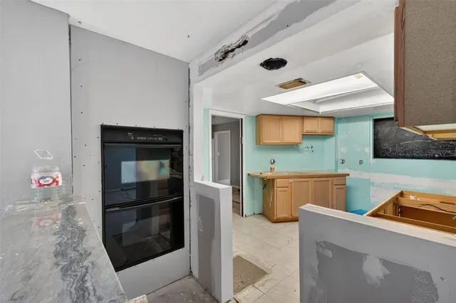 a kitchen with stainless steel appliances wooden cabinets and stove