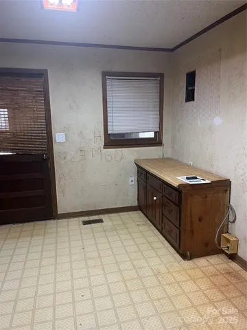 a white house with a big yard and large trees