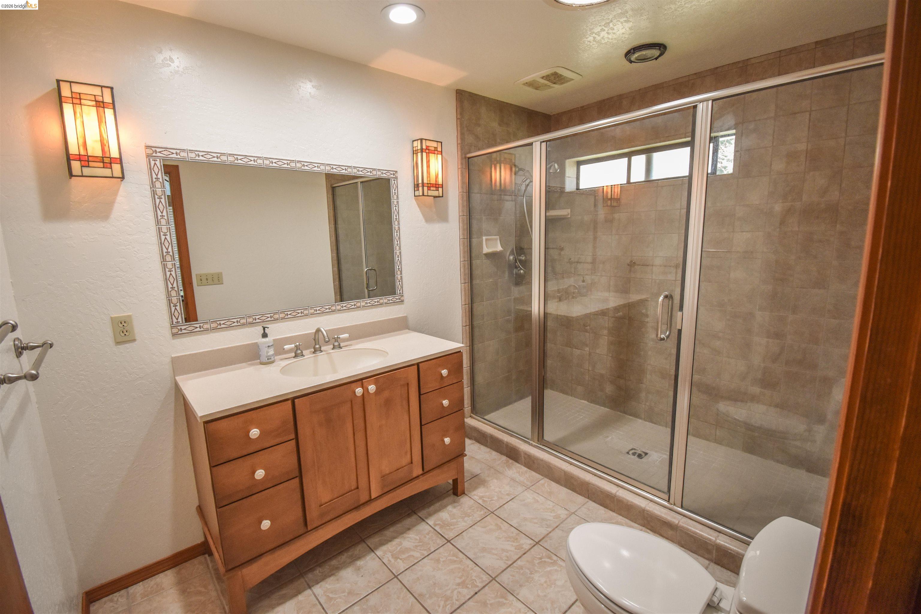 21515 Bellview Creek Road Sonora, CA 95370 - Photo 17 of 31 Bathroom with vanity, a shower stall, light tile patterned floors, and recessed lighting