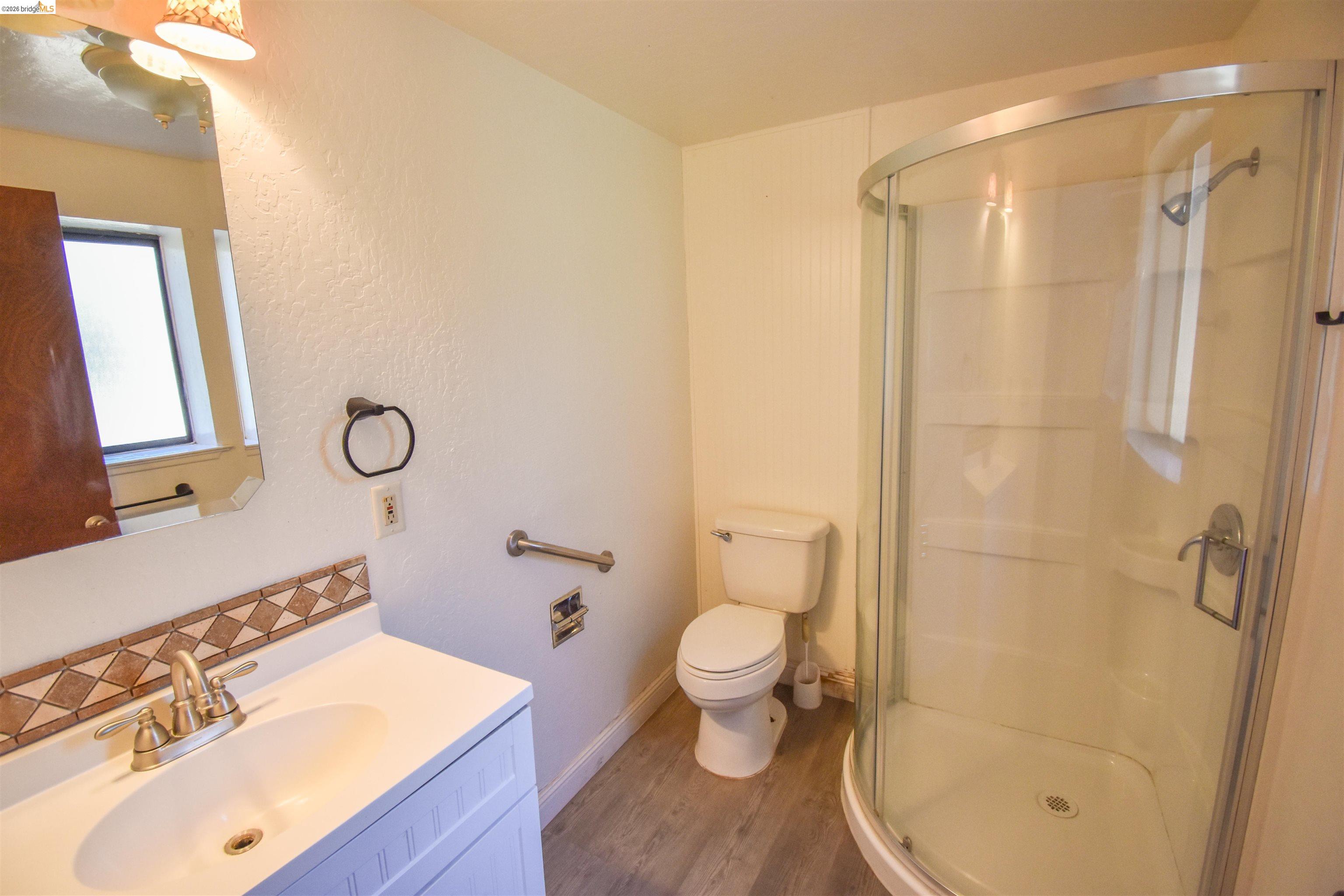 21515 Bellview Creek Road Sonora, CA 95370 - Photo 24 of 31 Bathroom with vanity, a stall shower, and dark wood finished floors