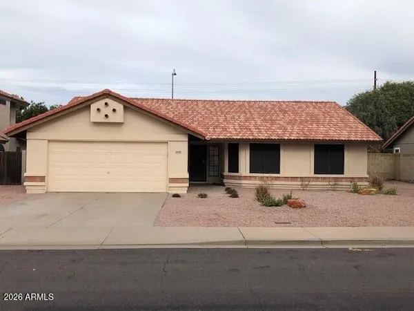 a front view of a house with garage and parking space
