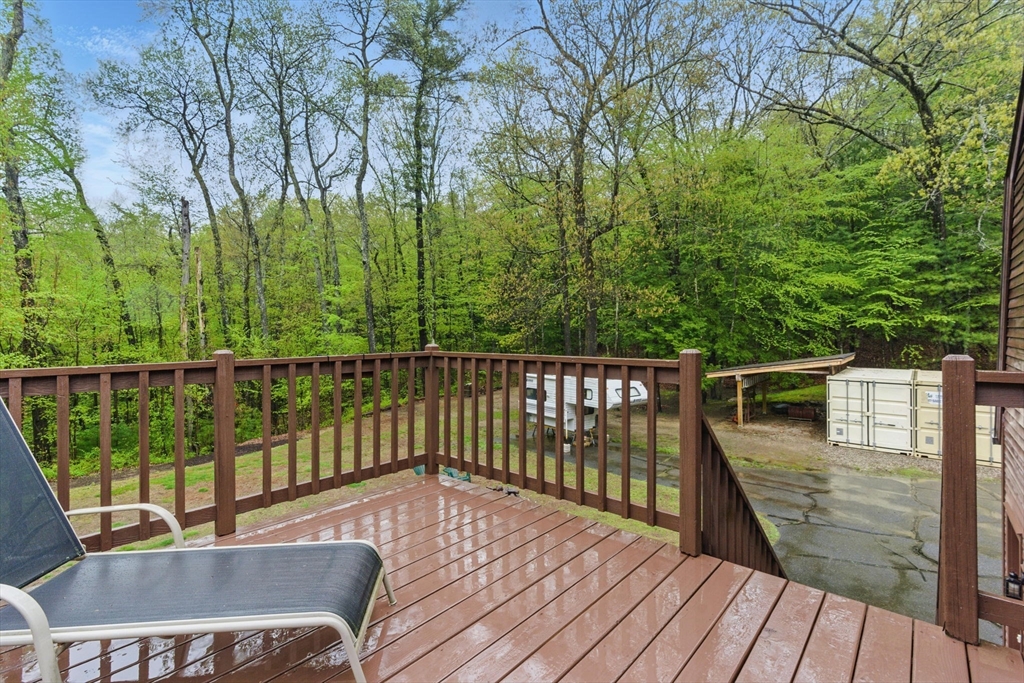 50 Claybrook Road Sunderland, MA 01375 - Photo 14 of 18 a balcony with wooden floor and trees in the back