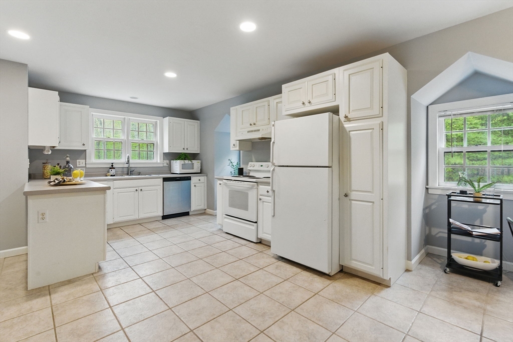 50 Claybrook Road Sunderland, MA 01375 - Photo 8 of 18 a kitchen with white cabinets and white appliances
