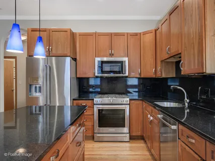 a kitchen with a sink a microwave a refrigerator and cabinets