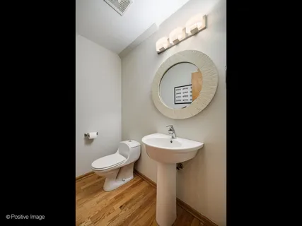 a bathroom with a toilet sink and a mirror