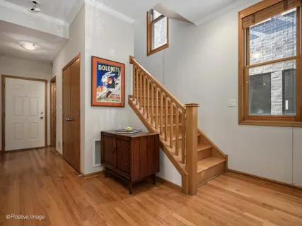 a view of front door with wooden floor and stairs