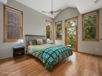 a bedroom with a bed window and a dresser