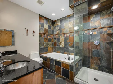 a bathroom with a tub sink and shower
