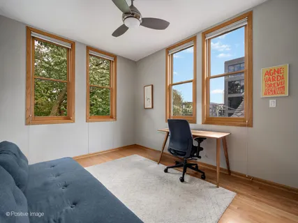 a workspace with wooden floor and windows