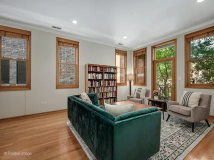 a living room with furniture and a book shelf