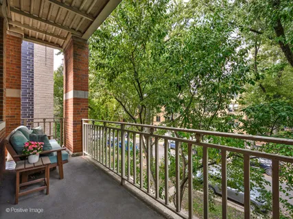 a view of a two chairs in the balcony