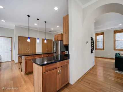 a kitchen with stainless steel appliances granite countertop a refrigerator a sink and a stove