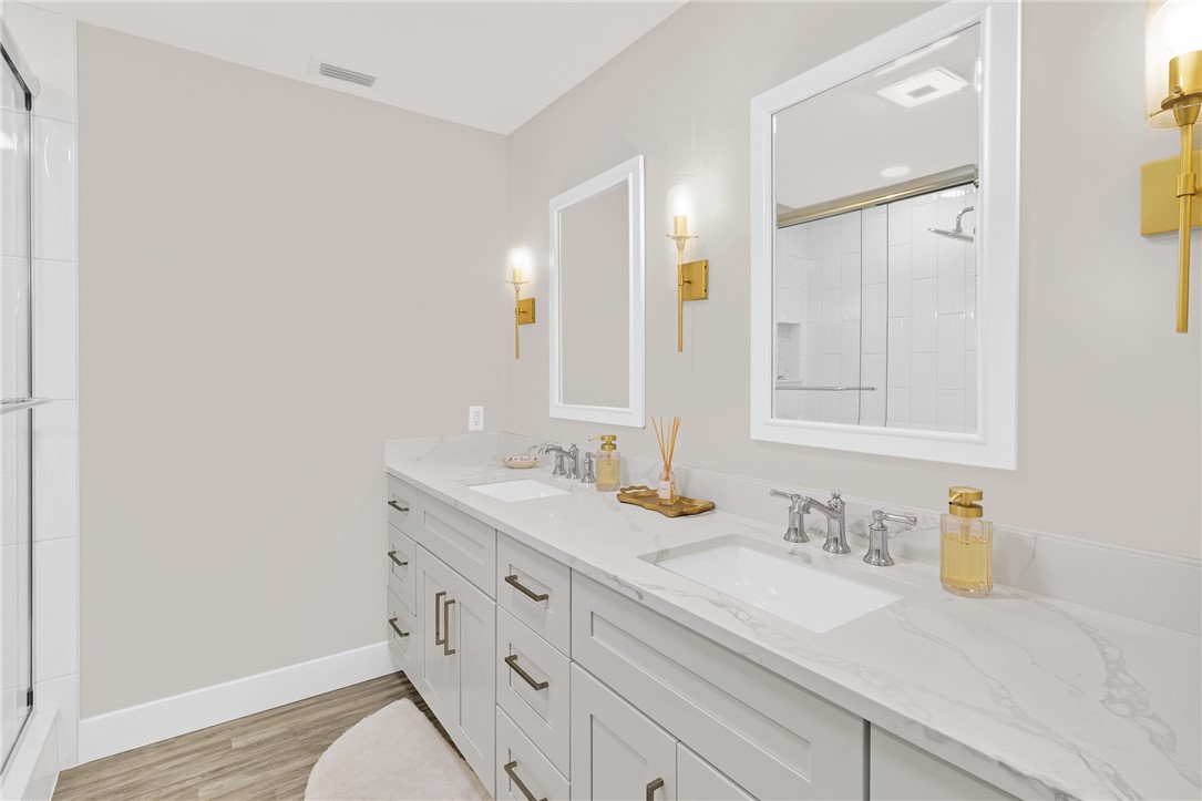 7989 143rd Street Sebastian, FL 32958 - Photo 14 of 30 a bathroom with a granite countertop sink and a mirror