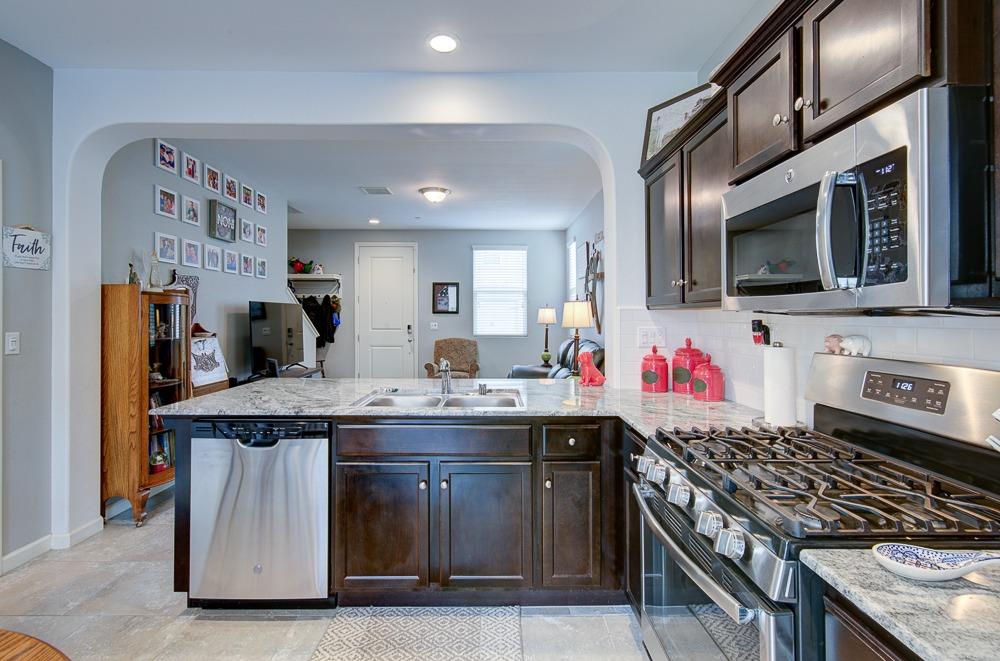 1530 Nabors Drive Clovis, CA 93619 - Photo 11 of 27 a kitchen with stainless steel appliances granite countertop a stove and a sink