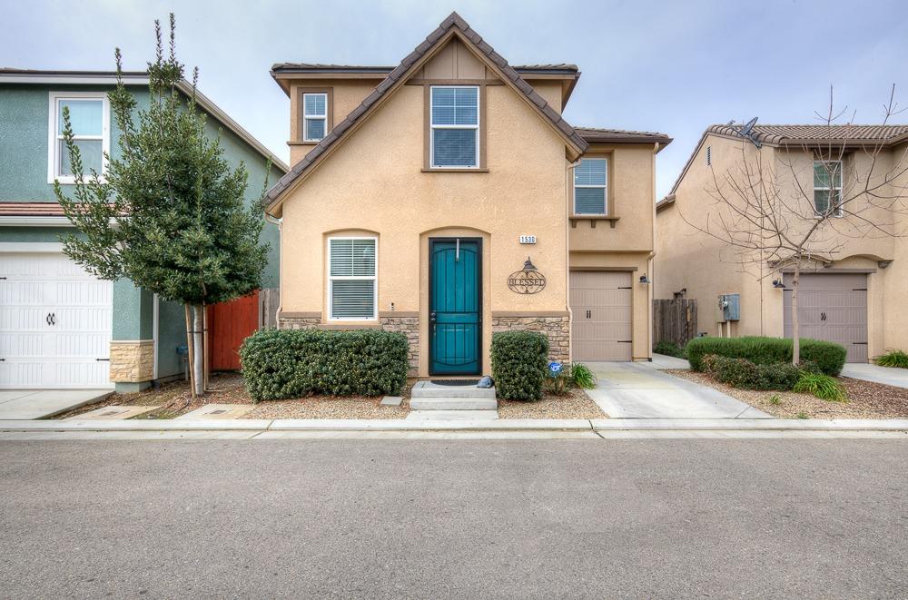1530 Nabors Drive Clovis, CA 93619 - Photo 2 of 27 a front view of a house with garden