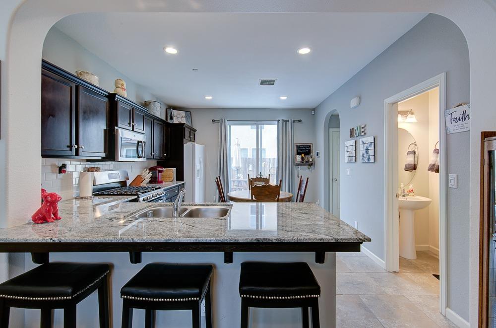 1530 Nabors Drive Clovis, CA 93619 - Photo 6 of 27 a kitchen with sink cabinets and refrigerator