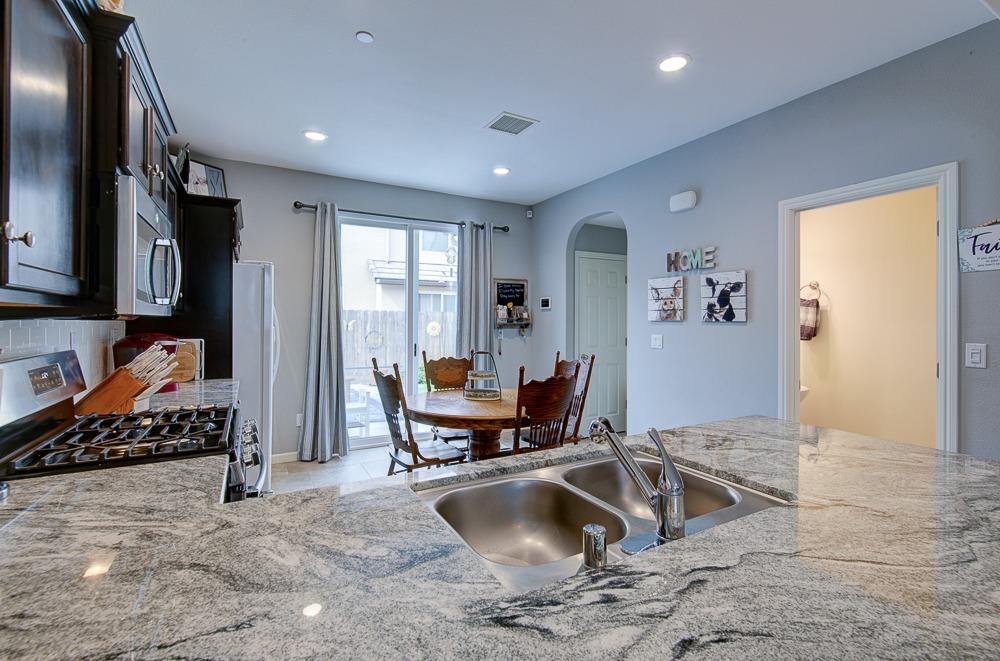 1530 Nabors Drive Clovis, CA 93619 - Photo 8 of 27 a kitchen with sink refrigerator and window