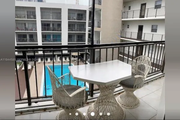 a view of a balcony with furniture