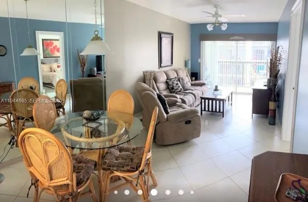 a living room with furniture a chandelier and a window