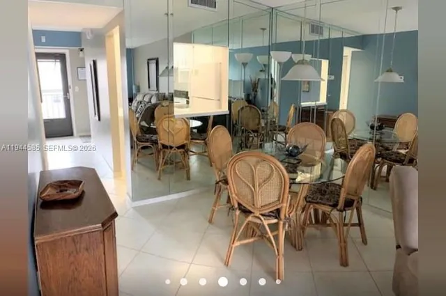 a view of a dining room with furniture and a chandelier