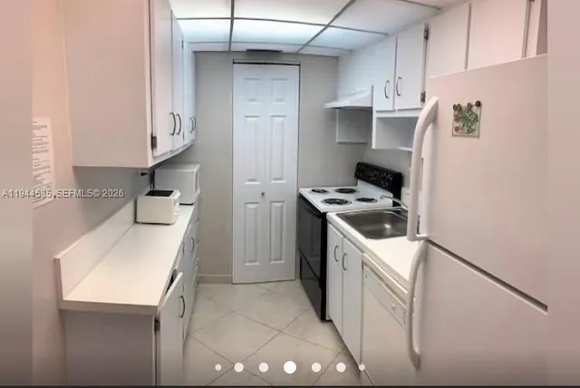 a kitchen with a sink a stove and refrigerator