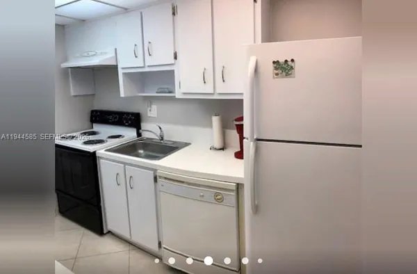 a kitchen with appliances cabinets and a counter top