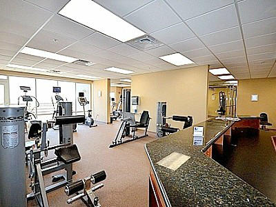 16819 Front Beach Road, Unit 1613 Panama City Beach, FL 32413 - Photo 4 of 8 a room with gym equipment and a view of living room