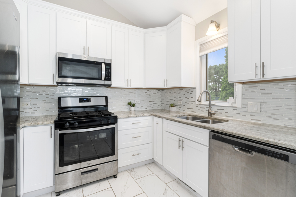 24849 Vermette Road Plainfield, IL 60585 - Photo 3 of 16 a kitchen with white cabinets appliances and a sink