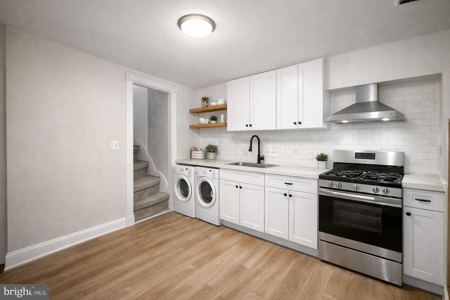 2535 Boyd Street Baltimore, MD 21223 - Photo 4 of 13 a kitchen with granite countertop a stove and a sink