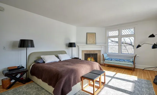 a bedroom with a bed and a fireplace