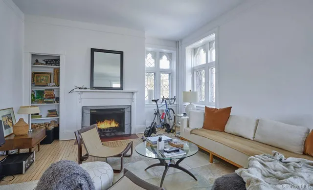a living room with furniture fireplace and window