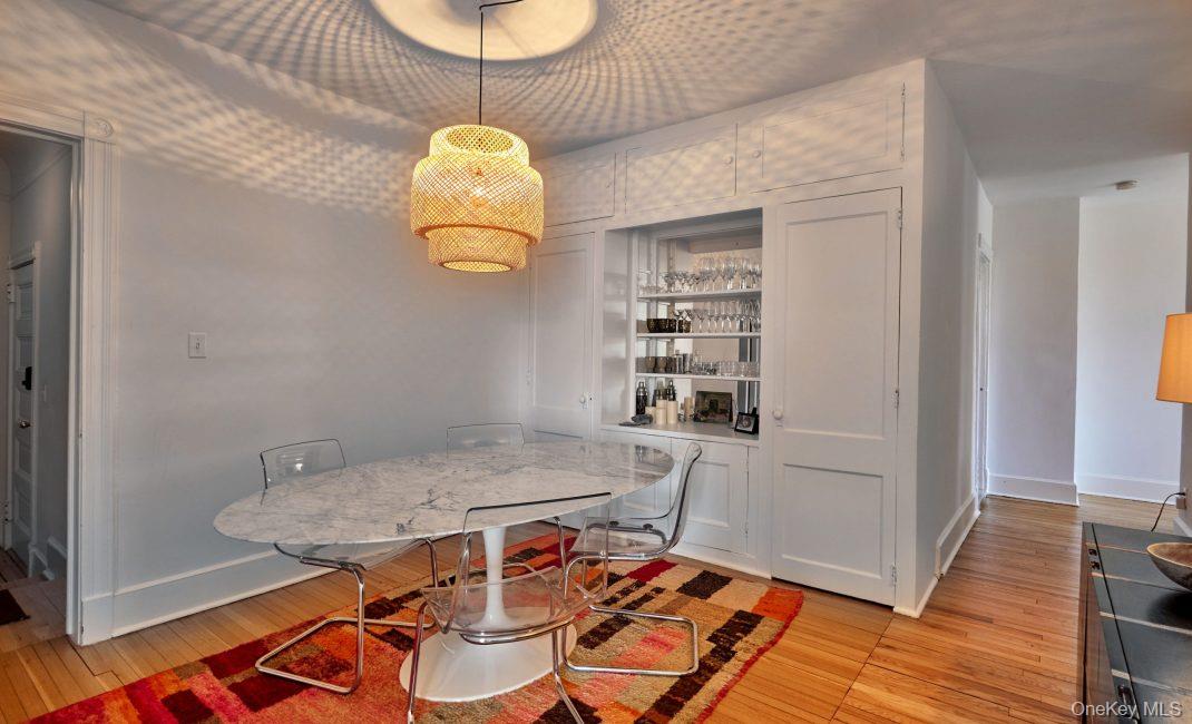 61 Crows Nest Road, Unit 5 Tuxedo Park, NY 10987 - Photo 4 of 16 a dining room with a table and chairs