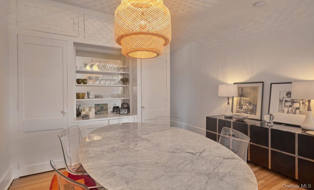 61 Crows Nest Road, Unit 5 Tuxedo Park, NY 10987 - Photo 5 of 16 a bedroom with a bed and a chandelier